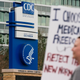{Pro-coronavirus protesters outside the CDC headquarters in Atlanta, Georgia on March 13, 2021, when national statistics show 1,873 deaths from the virus.